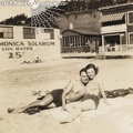 Girl in bathing suit with boyfriend at Santa Monica Beach, Los Angeles, California.