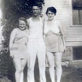 Man In Between Two Women In Bathing Suits