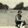 Young Lady At The Corner Of An Unpaved Street