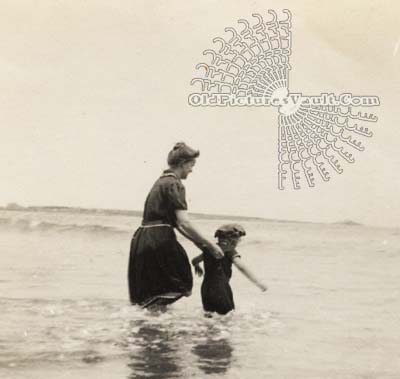 mother-helping-daughter-into-the-waves.jpg
